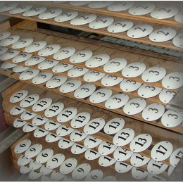 Oval numbers enamelled and silk-screened awaiting cooking