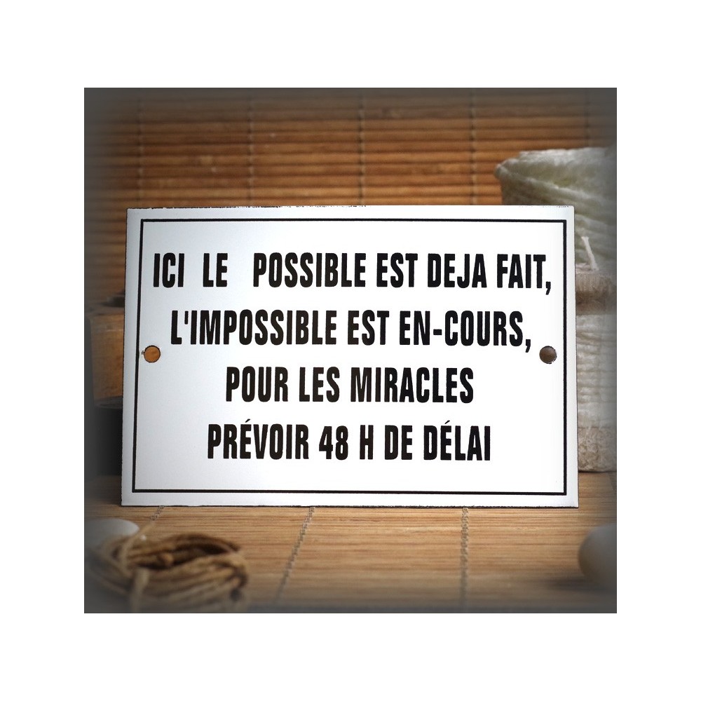 Enamel plate with French text "Ici le possible est déjà fait"
